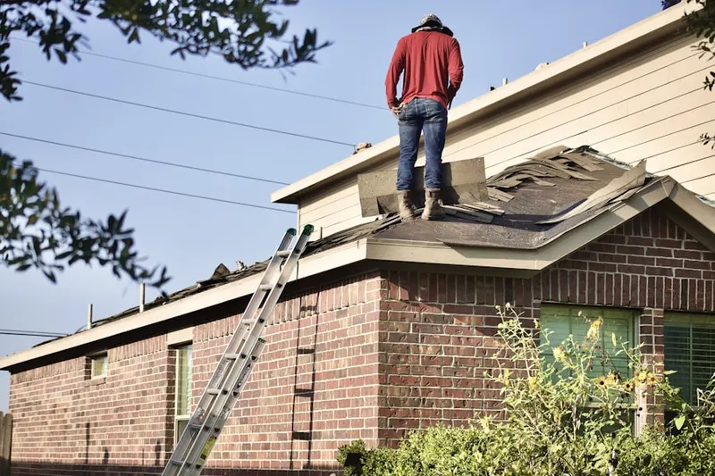 Professional roofer working on a residential roof in Westwood